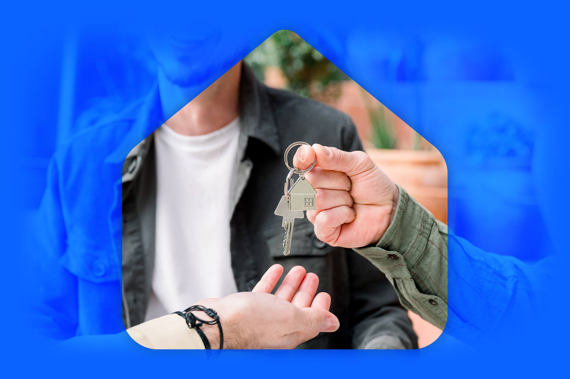A person handing keys off to another person in a house outline symbolizing an assumable mortgage