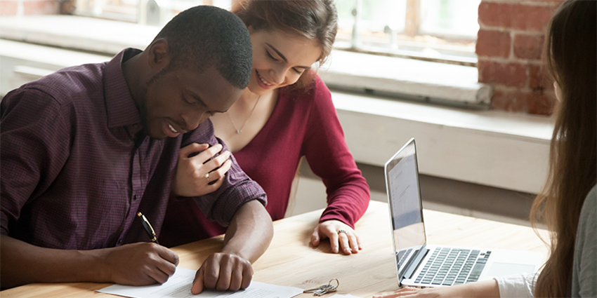 A couple signing papers